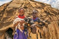 Girls from the African tribe Daasanach holding goats