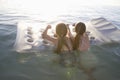 Girls On Air Mattress Floating On Water