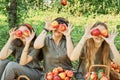 Girls with Apple in the Apple Orchard. Beautiful sisters with Organic Apple in the Orchard. Harvest Concept. Garden, teenagers Royalty Free Stock Photo