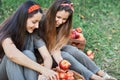 Girls with Apple in the Apple Orchard. Beautiful sisters with Organic Apple in the Orchard. Harvest Concept. Garden, teenagers Royalty Free Stock Photo