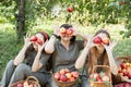 Girls with Apple in the Apple Orchard. Beautiful sisters with Organic Apple in the Orchard. Harvest Concept. Garden, teenagers Royalty Free Stock Photo