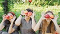 Girls with Apple in the Apple Orchard. Beautiful sisters with Organic Apple in the Orchard. Harvest Concept. Garden, teenagers Royalty Free Stock Photo