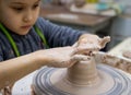 Girl 6 years old works on a pottery wheel, close-up of hands. Royalty Free Stock Photo
