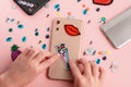 Girls attaching embroidered patches and rhinestones on beige phone case