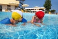 Girls bath in pool near skirting on rest Royalty Free Stock Photo