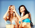 Girls in bikinis with ice cream on the beach Royalty Free Stock Photo