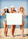 Girls with blank board on the beach Royalty Free Stock Photo
