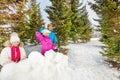 Girls and boy playing snowballs game fight Royalty Free Stock Photo
