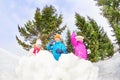 Girls and boy playing snowballs game in forest Royalty Free Stock Photo