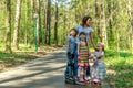 Girls and boy in protective equipment and rollers scating Royalty Free Stock Photo