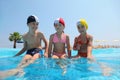 Girls and boy sit on skirting in pool and speak Royalty Free Stock Photo