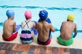 Girls and boys sitting at poolside Royalty Free Stock Photo