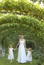 Girls And Bride Walking Under Ivy Arches