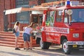 Girls buy coffee in mobile coffee shop on wheels