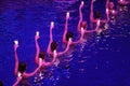 Girls with candles in their hands performing in pool