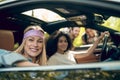 Girls in the car flirting with men on the road Royalty Free Stock Photo