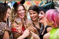 Girls at Carnival parade clinking glasses with champagne Royalty Free Stock Photo