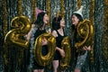 Girls carrying gold colored numbers 2019 Royalty Free Stock Photo