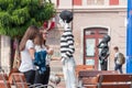 Girls checking out a mime mannequin in the street