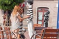 Girls checking out a mime mannequin in the street