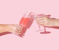 Girls cheers concept. Two woman hands, one with vitiligo hand holding vintage crystal glasses with lovely drinks in it against