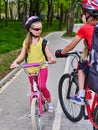 Girls children cycling on spring yellow bike lane. Royalty Free Stock Photo