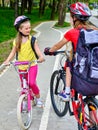 Girls children cycling on yellow bike lane. Royalty Free Stock Photo