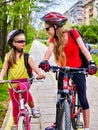 Girls children cycling on yellow bike lane. Royalty Free Stock Photo