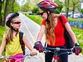 Girls children cycling on yellow bike lane. Royalty Free Stock Photo