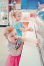 Girls children sisters friends looking at ice cream shop window