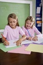 Girls in classroom doing schoolwork, writing Royalty Free Stock Photo