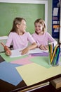 Girls in classroom doing schoolwork, writing Royalty Free Stock Photo