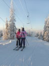 The girls climb the slopes on a ski lift on a rope tow independently. Royalty Free Stock Photo