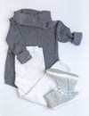 Girls clothing for spring. Gray knitted sweater, white jeans an