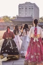 Girls in colorful traditional Korean folklore costumes hanboks walking in Gyeongbokgung palace in Seoul South Korea