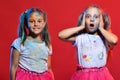 Girls with confused and happy faces stand on red background Royalty Free Stock Photo