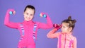 Girls cute kid exercising with dumbbells. Motivation and sport example concept. Toddler repeat exercise after sister