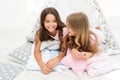 Girls in cute pajamas spend time together in bedroom. Sisters communicate while relax in bedroom. Family time. Sisters Royalty Free Stock Photo