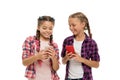 Girls cute small children smiling to phone screen. They like internet surfing social networks. Problem of young