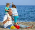 Girls with dad on sea shore Royalty Free Stock Photo