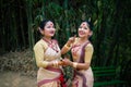 Girls in dance move isolated dressed in traditional wearing on festival with blurred background