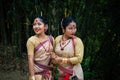 Girls in dance move isolated dressed in traditional wearing on festival with blurred background