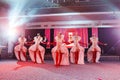 Girls dancers in beautiful stage costumes dancing at a festive banquet.