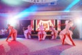 Girls dancers in beautiful stage costumes dancing at a festive banquet.