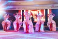 Girls dancers in beautiful stage costumes dancing at a festive banquet.