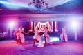 Girls dancers in beautiful stage costumes dancing at a festive banquet.