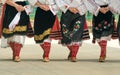 Girls dancing folk dance. People in traditional costumes dance Bulgarian folk dances. Close-up of female legs with traditional Royalty Free Stock Photo