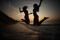 Girls DANCING IN SUNSET ON SEA Royalty Free Stock Photo