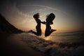 Girls DANCING IN SUNSET ON SEA Royalty Free Stock Photo