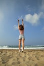 A girls does fitness on a white sand beach, Rethymno, Crete, Greece Royalty Free Stock Photo